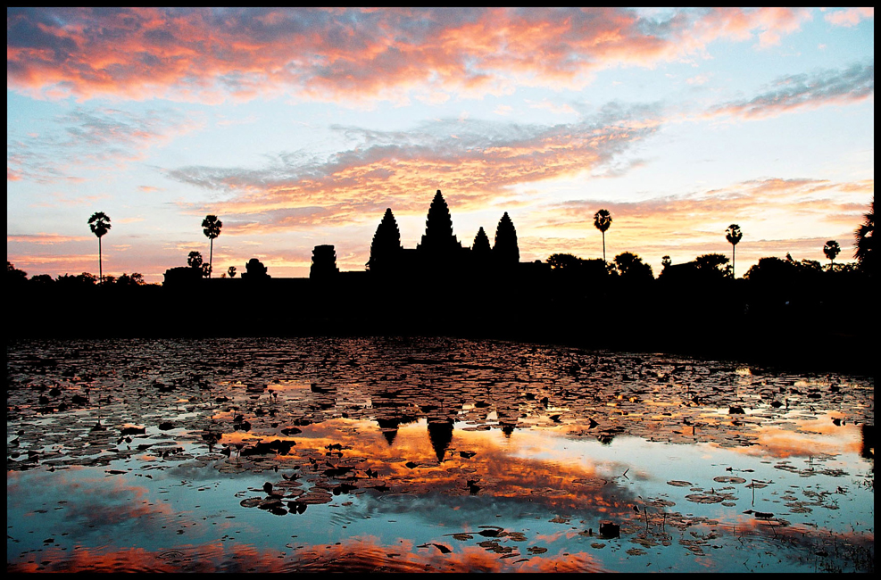 Angkor Wat towers and temple complex in the warm light of sunrise in Siem Reap Cambodia