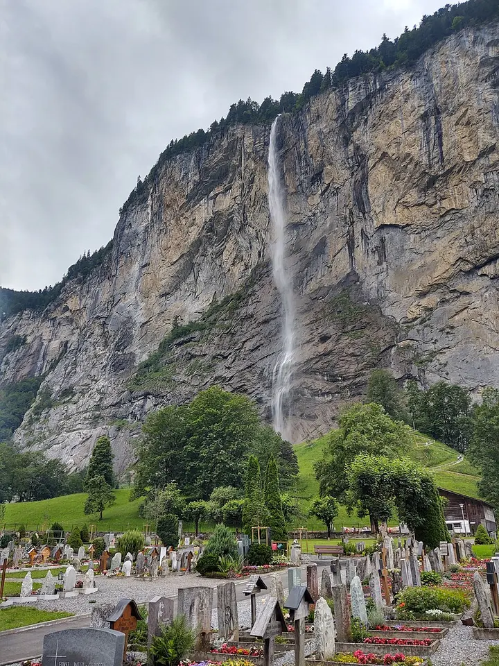 Staubbach Falls descending beside Lauterbrunnen village